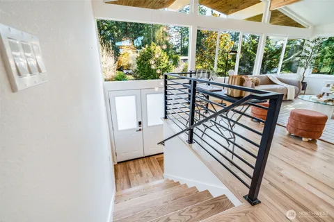 a living room with large windows and furniture