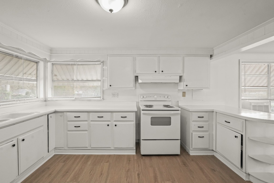 105 West Linney Street Dayton, TX 77535 - Photo 11 of 48 a kitchen with white cabinets white stainless steel appliances and sink