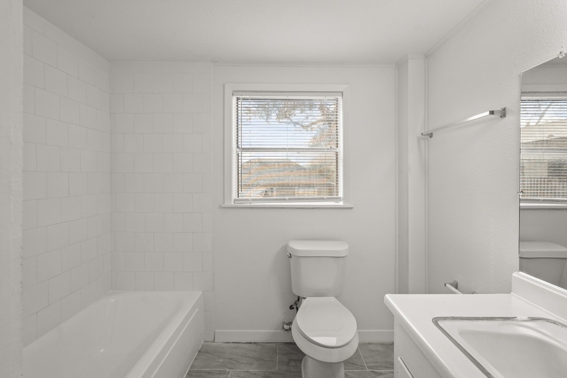 105 West Linney Street Dayton, TX 77535 - Photo 14 of 48 a white toilet sitting next to a bath tub
