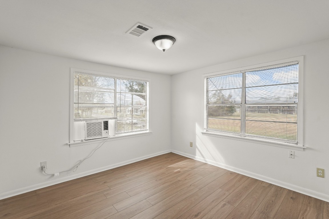 105 West Linney Street Dayton, TX 77535 - Photo 15 of 48 an empty room with wooden floor and windows