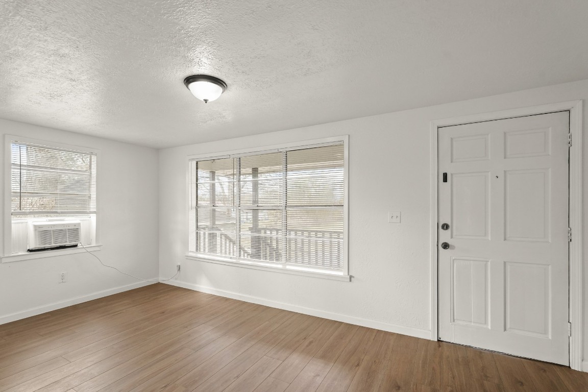 105 West Linney Street Dayton, TX 77535 - Photo 16 of 48 a view of an empty room with wooden floor and a window