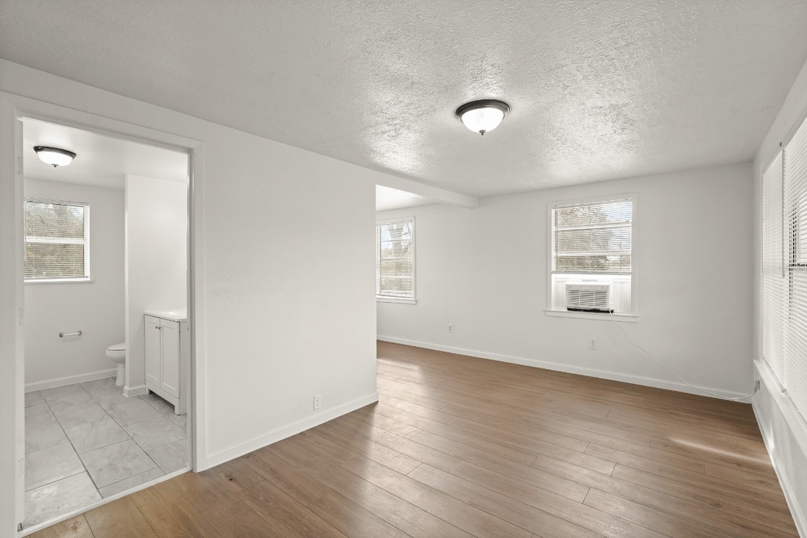 105 West Linney Street Dayton, TX 77535 - Photo 17 of 48 an empty room with wooden floor and windows