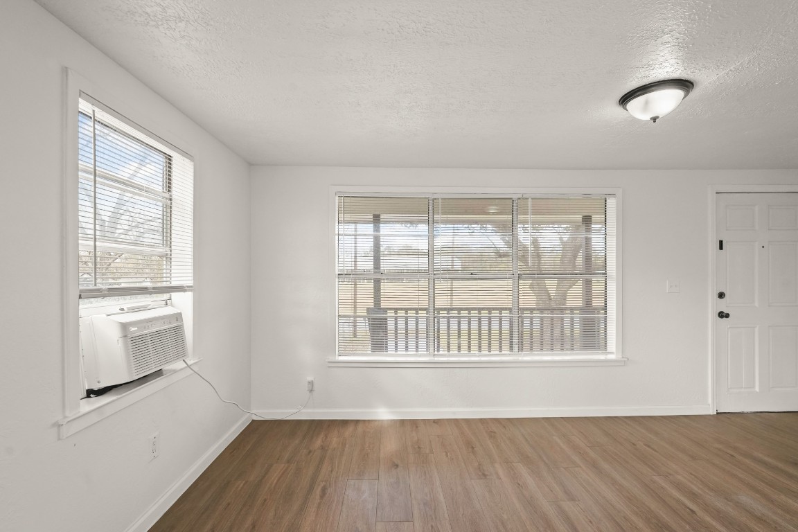 105 West Linney Street Dayton, TX 77535 - Photo 18 of 48 an empty room with wooden floor and windows
