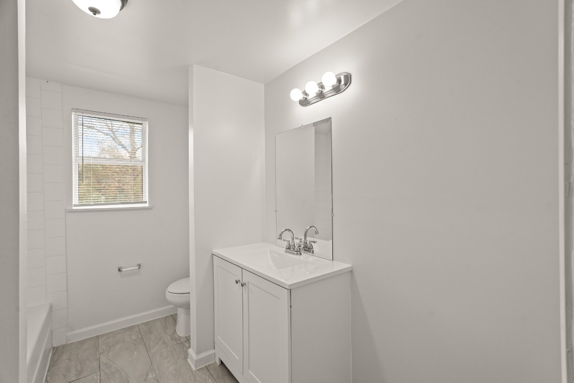 105 West Linney Street Dayton, TX 77535 - Photo 20 of 48 a bathroom with a toilet sink and mirror