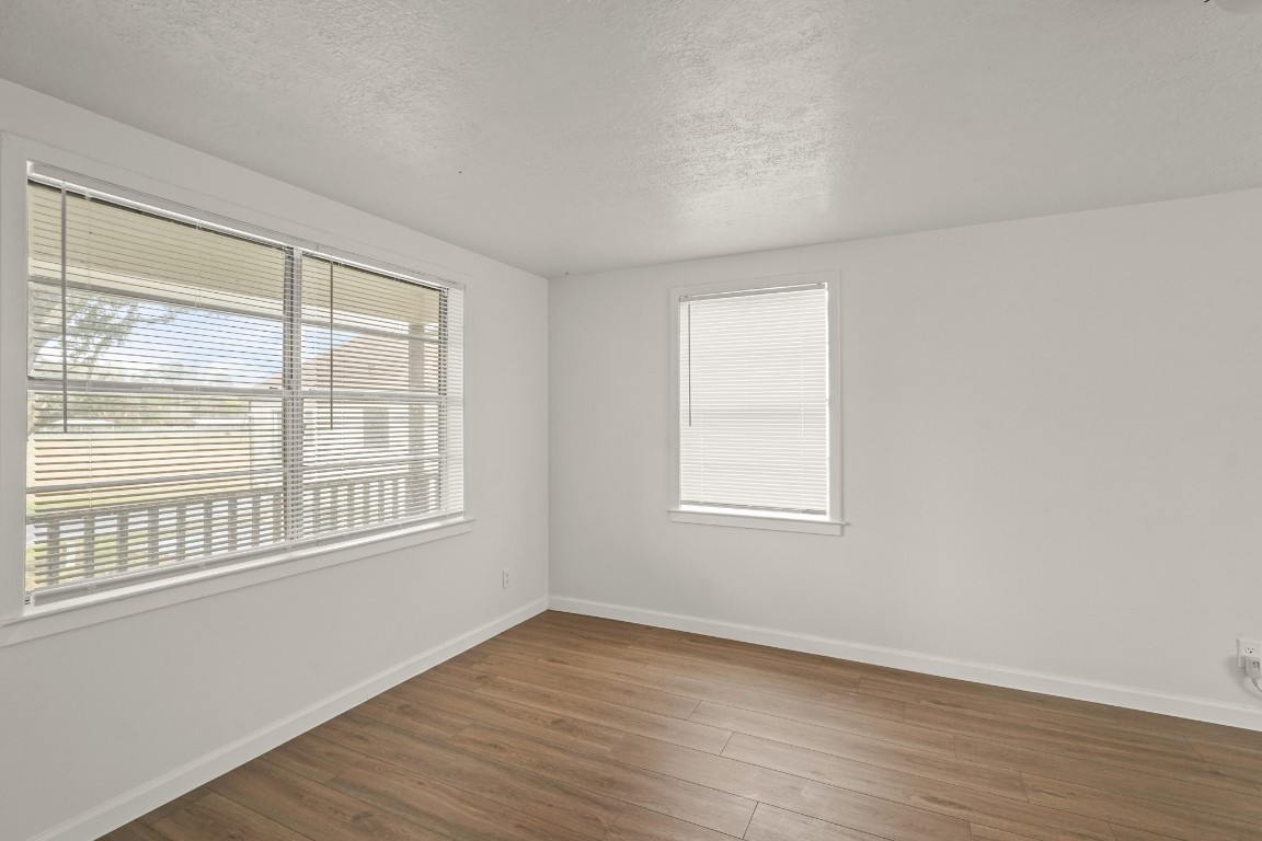 105 West Linney Street Dayton, TX 77535 - Photo 23 of 48 an empty room with wooden floor and windows