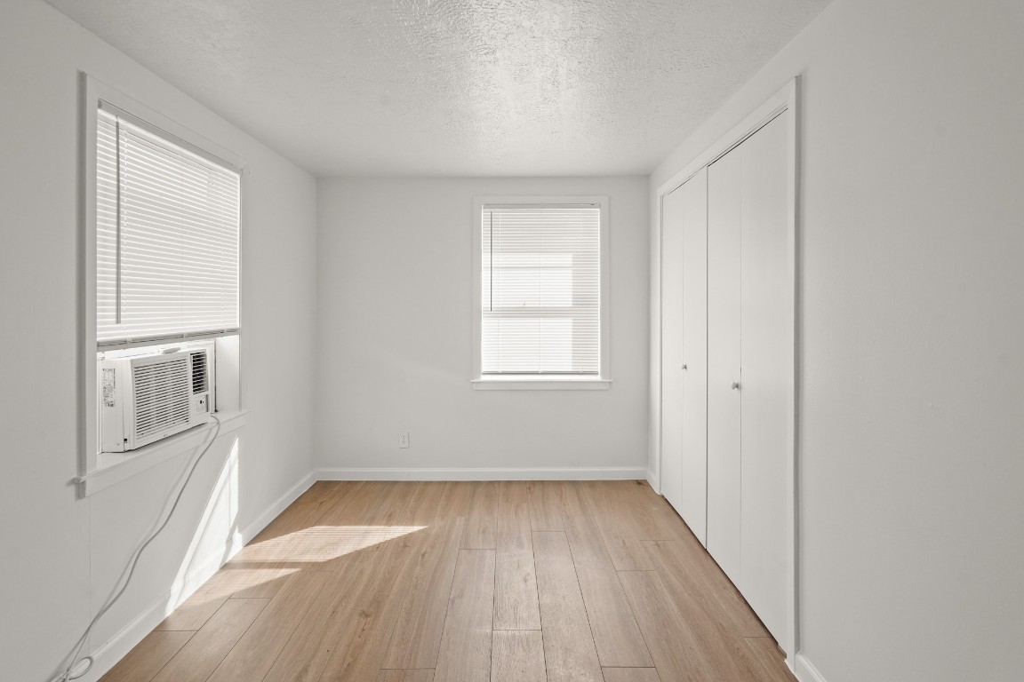 105 West Linney Street Dayton, TX 77535 - Photo 24 of 48 an empty room with wooden floor and windows