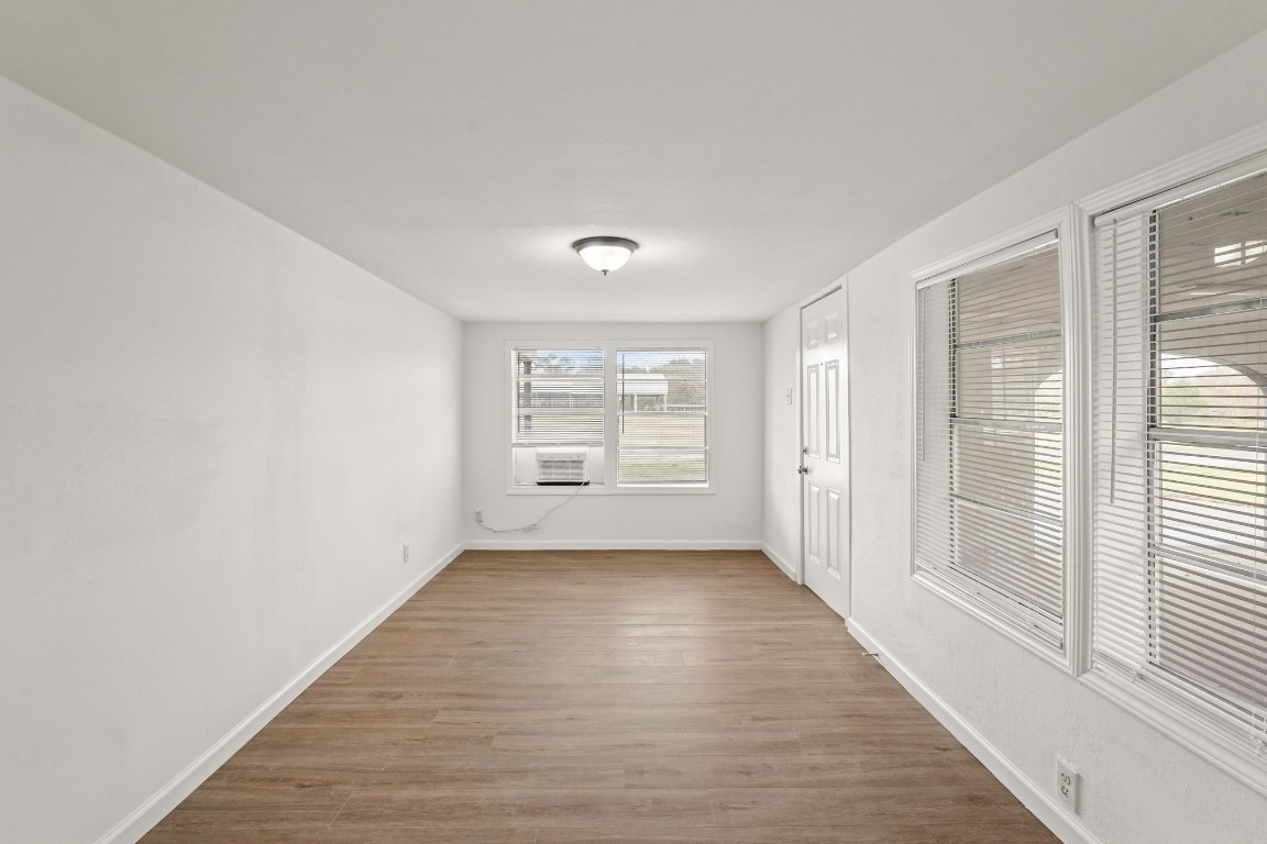 105 West Linney Street Dayton, TX 77535 - Photo 44 of 48 a view of an empty room with wooden floor and a window