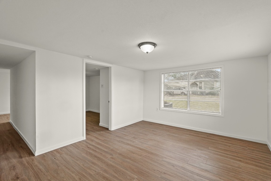 105 West Linney Street Dayton, TX 77535 - Photo 45 of 48 an empty room with wooden floor and window