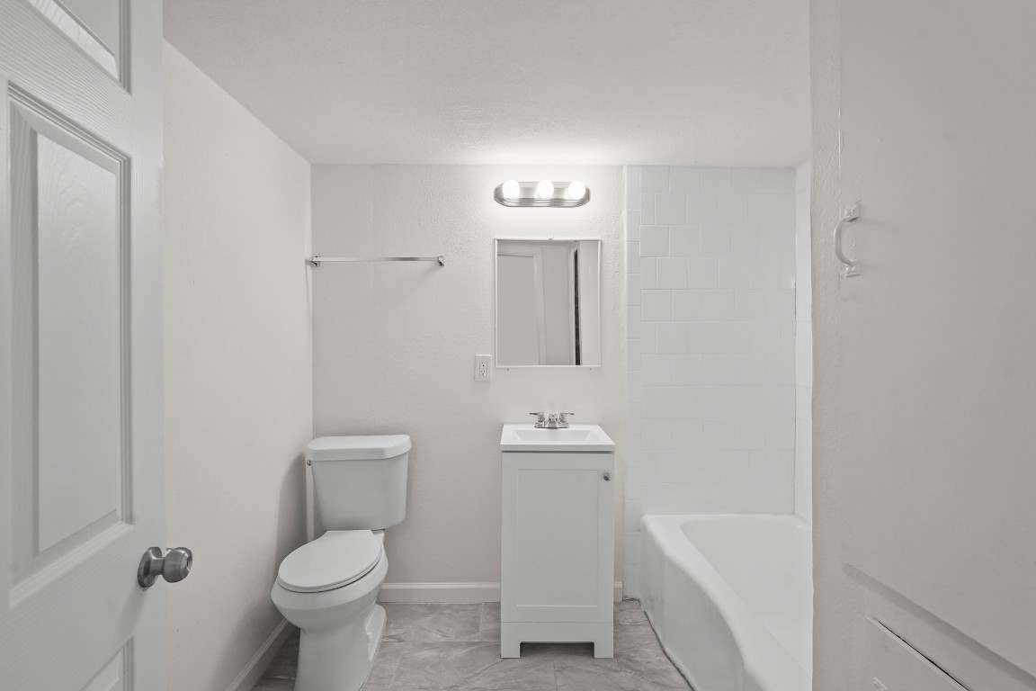 105 West Linney Street Dayton, TX 77535 - Photo 47 of 48 a bathroom with a toilet sink and mirror