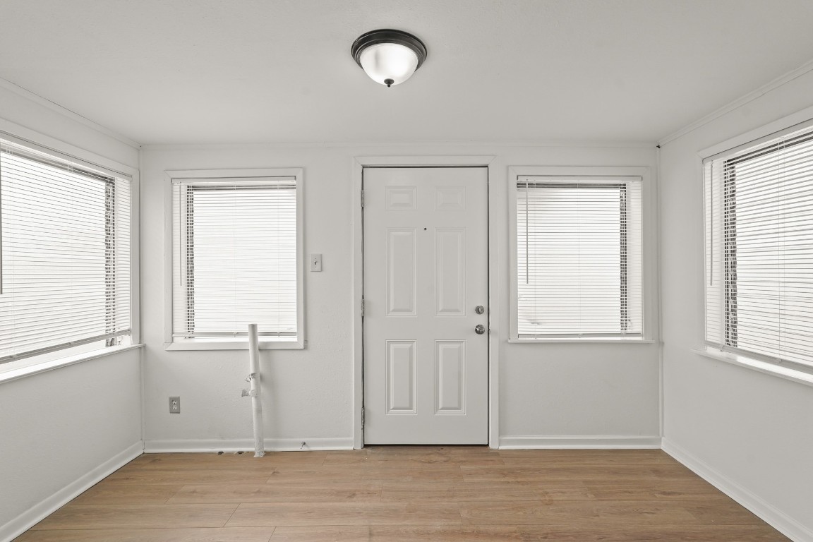 105 West Linney Street Dayton, TX 77535 - Photo 8 of 48 an empty room with wooden floor and windows