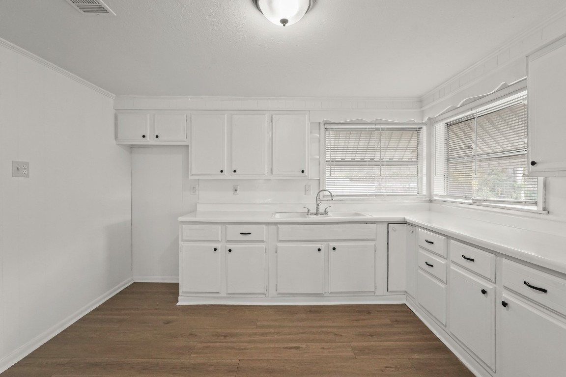 105 West Linney Street Dayton, TX 77535 - Photo 10 of 48 a kitchen with granite countertop white cabinets white appliances with a sink and dishwasher