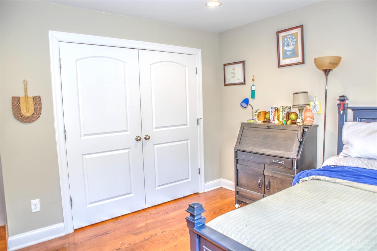 214 Oxford Road Edison, NJ 08820 - Photo 34 of 51 a room with a bed and a table in it