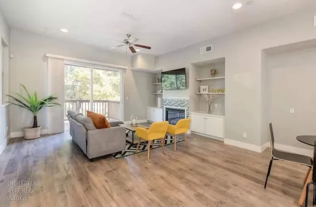 a living room with furniture and wooden floor
