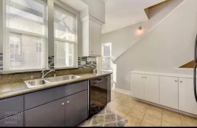 a bathroom with a granite countertop sink and a large mirror