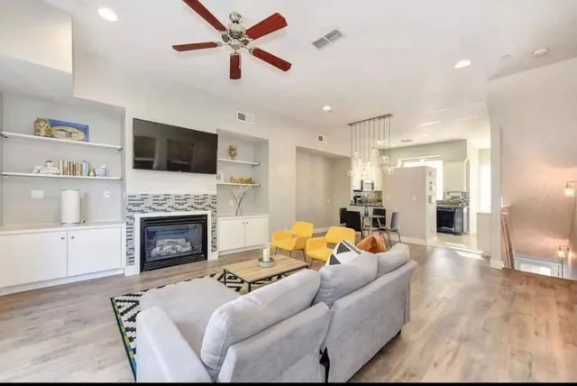 a living room with furniture a fireplace and a flat screen tv
