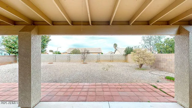 a view of a room with a ceiling fan and windows