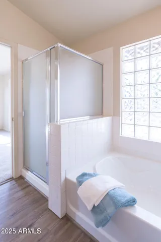 an empty room with windows and chandelier fan