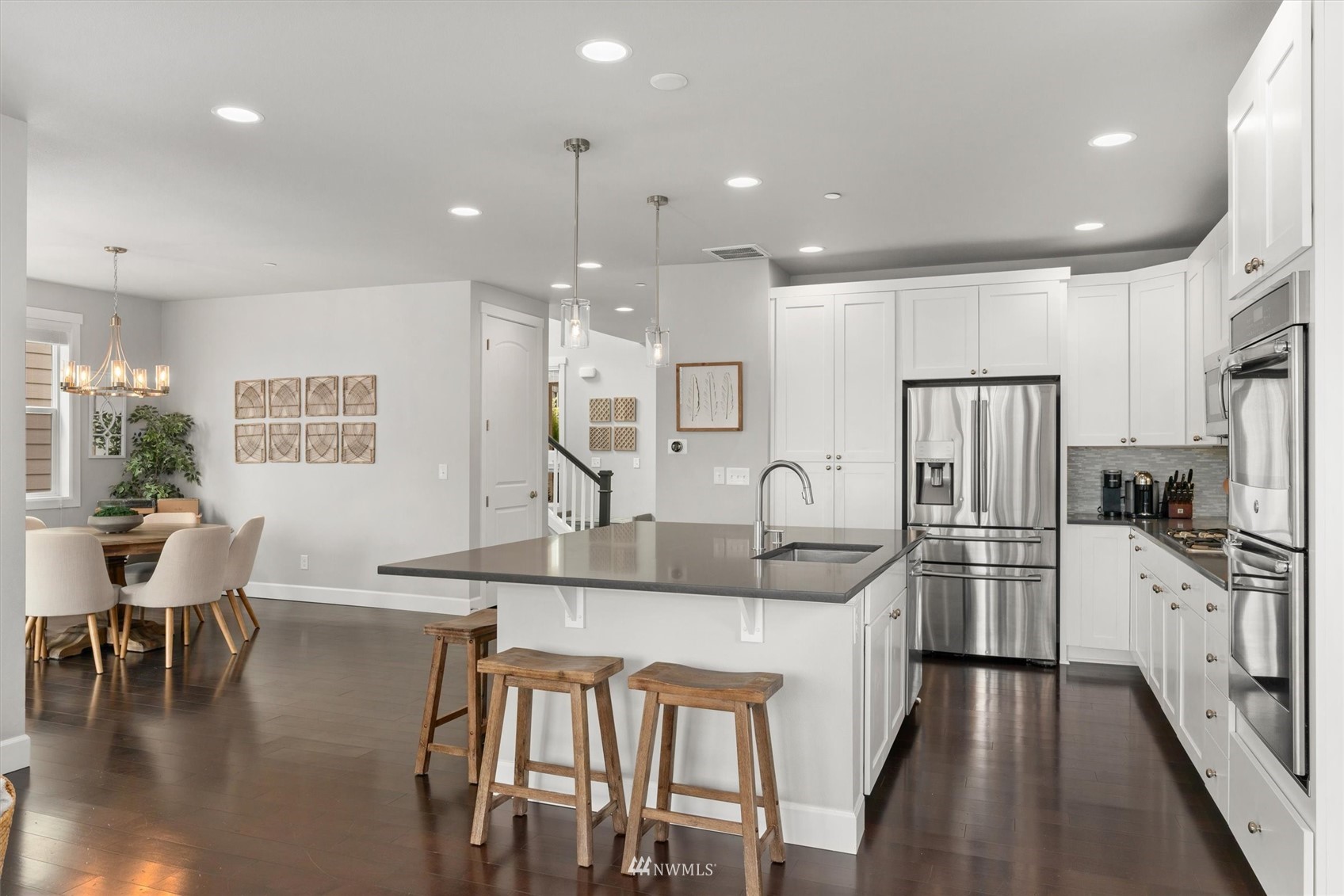 18307 3rd Drive Southeast Bothell, WA 98012 - Photo 7 of 40 a kitchen with stainless steel appliances granite countertop a kitchen island hardwood floor and a sink