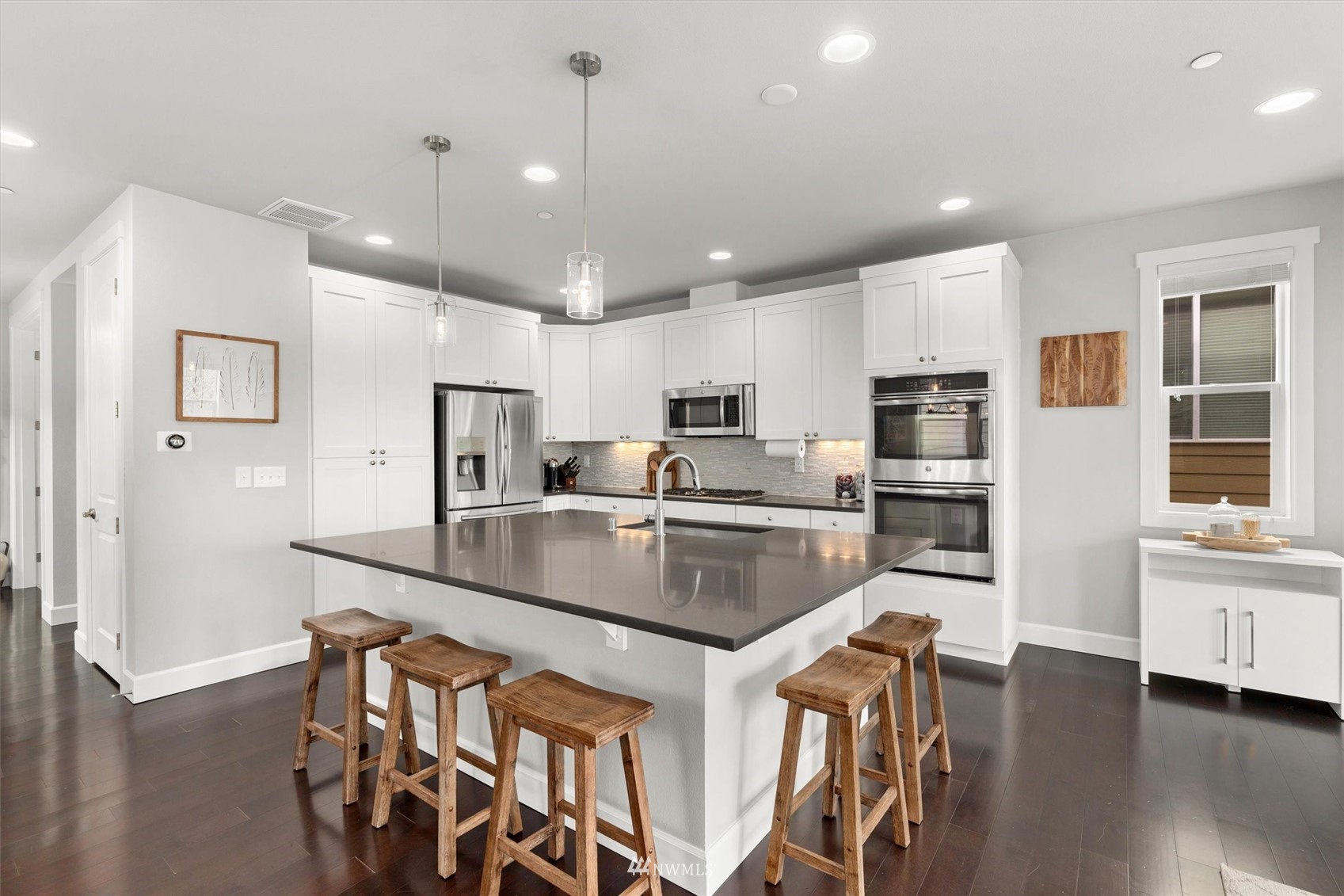 18307 3rd Drive Southeast Bothell, WA 98012 - Photo 8 of 40 a kitchen with stainless steel appliances granite countertop a sink a stove a refrigerator and island with wooden floor
