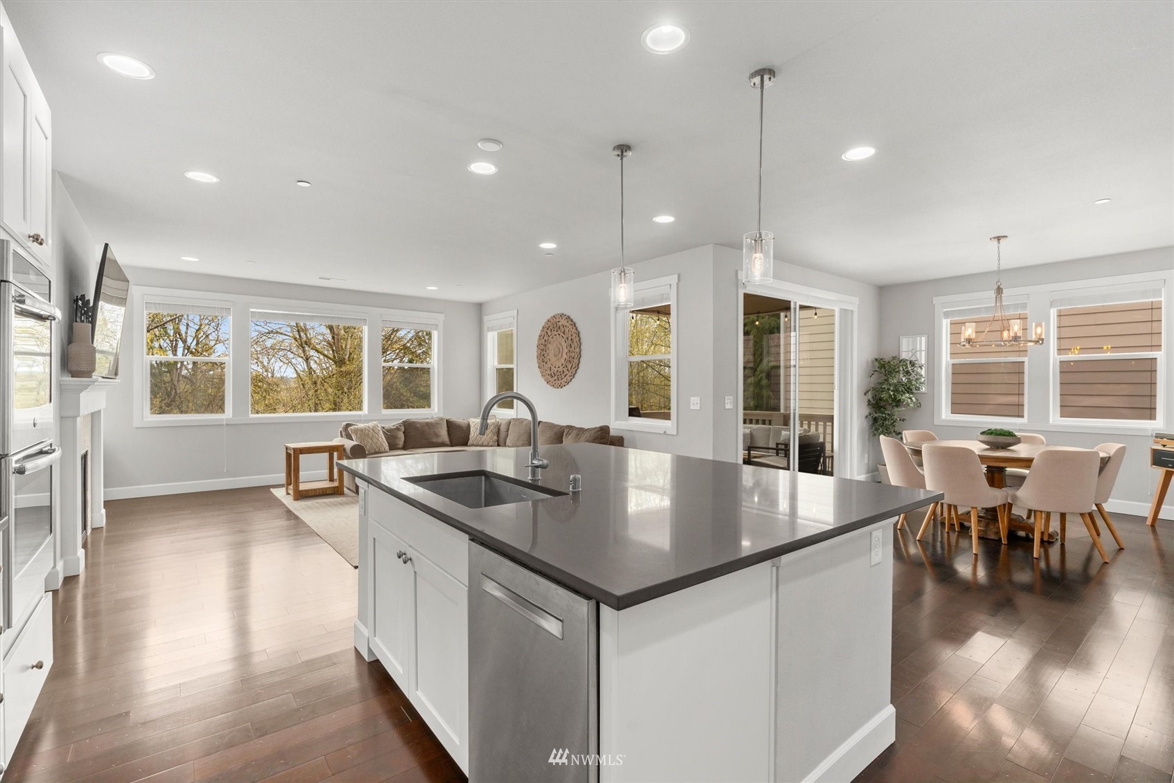 18307 3rd Drive Southeast Bothell, WA 98012 - Photo 9 of 40 a kitchen with center island wooden floor wooden floor and stainless steel appliances