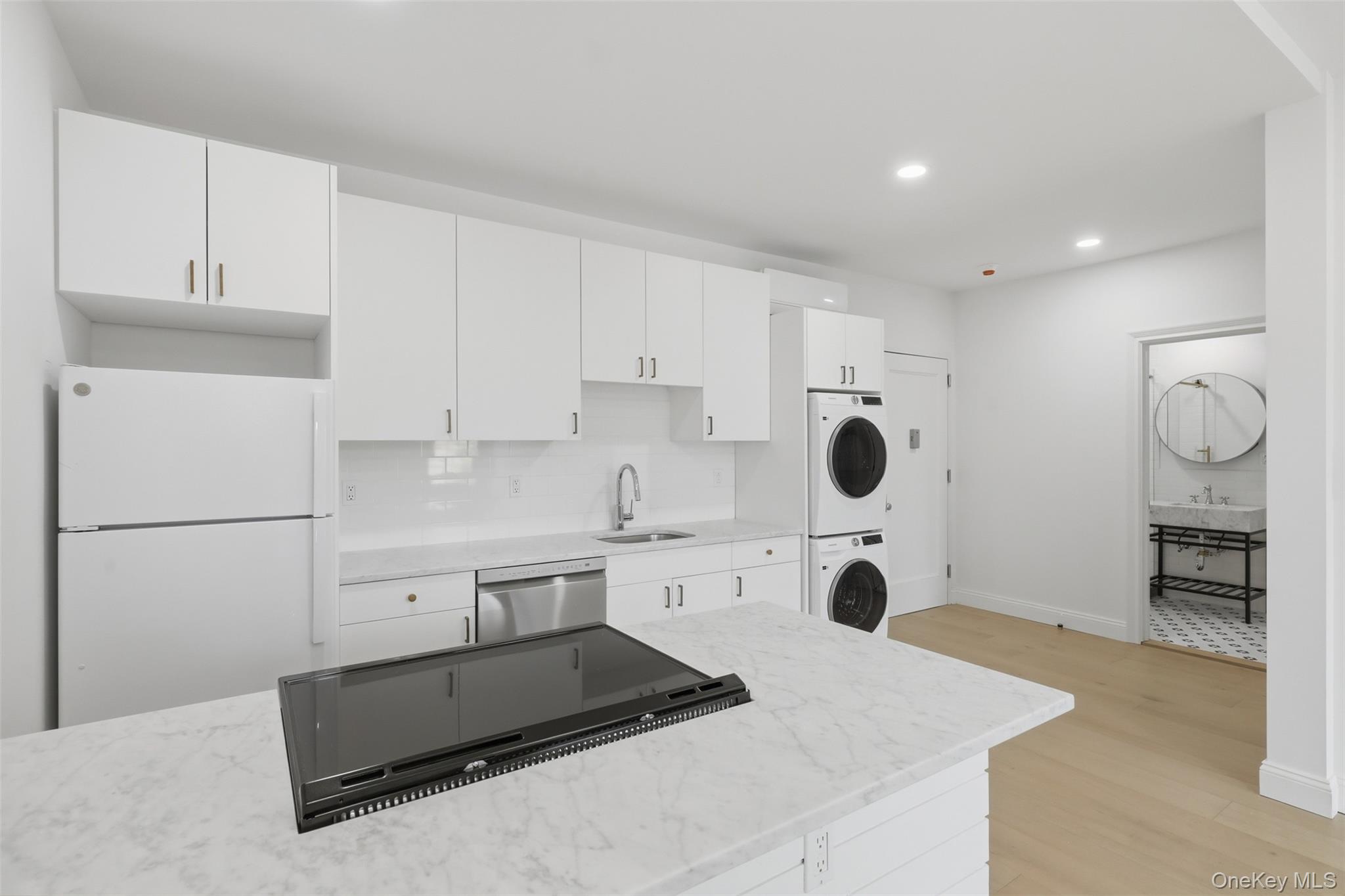 207 Main Street, Unit 3 Beacon, NY 12508 - Photo 12 of 23 a kitchen with white cabinets and refrigerator