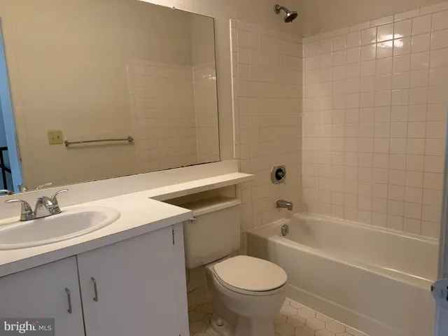a bathroom with a sink toilet vanity and bathtub