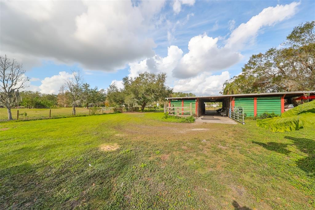 15624 Carlton Lake Road Wimauma, FL 33598 - Photo 11 of 35 a view of a big yard with a house