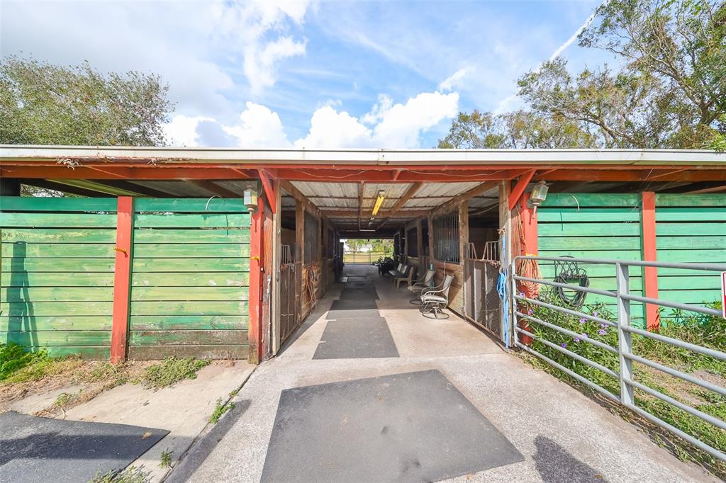 15624 Carlton Lake Road Wimauma, FL 33598 - Photo 12 of 35 a view of a patio with table and chairs a barbeque with wooden fence