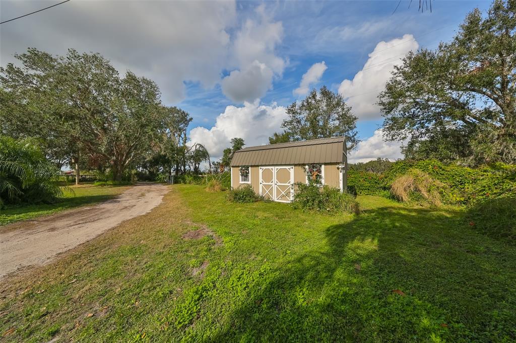 15624 Carlton Lake Road Wimauma, FL 33598 - Photo 28 of 35 a view of a house with a yard