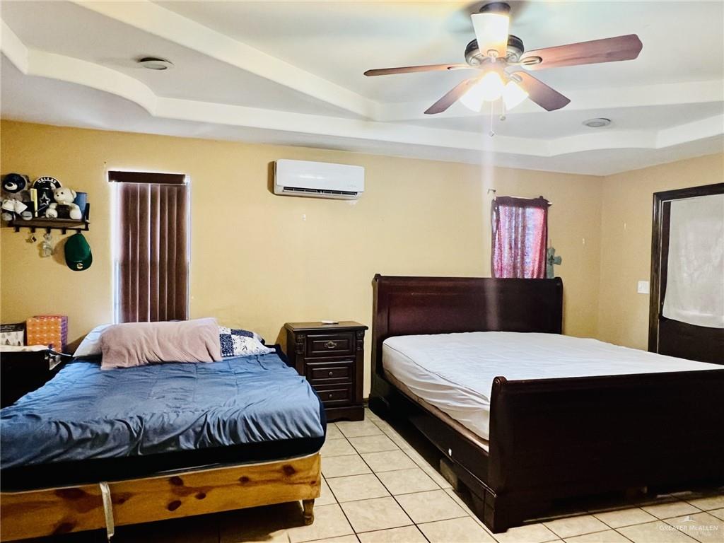 5 Montalvo Hill Road Rio Grande City, TX 78582 - Photo 15 of 42 a bedroom with a bed and a chandelier