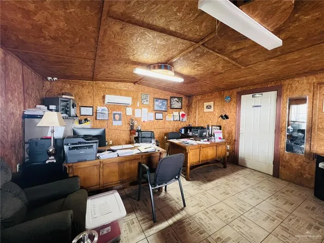 a living room with lots of furniture and kitchen view