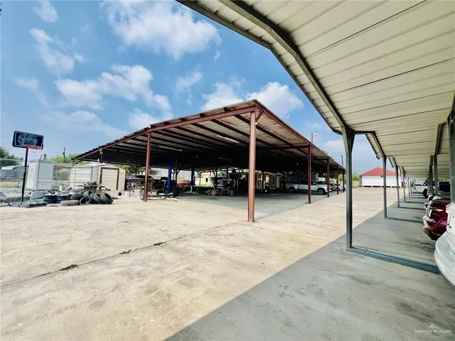 a view of a house with a barbeque and trees