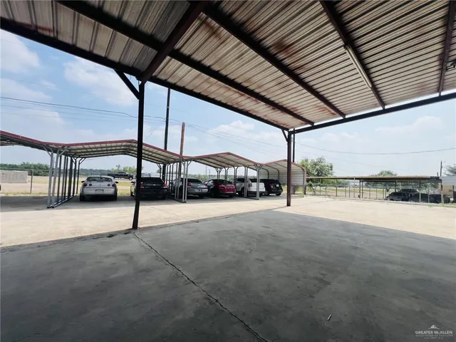 a view of garage with cars