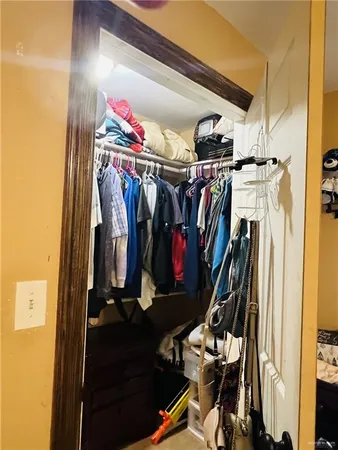 a patio with table and chairs and potted plants