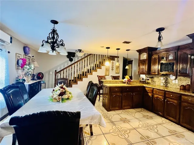 a living room with kitchen island furniture and a chandelier