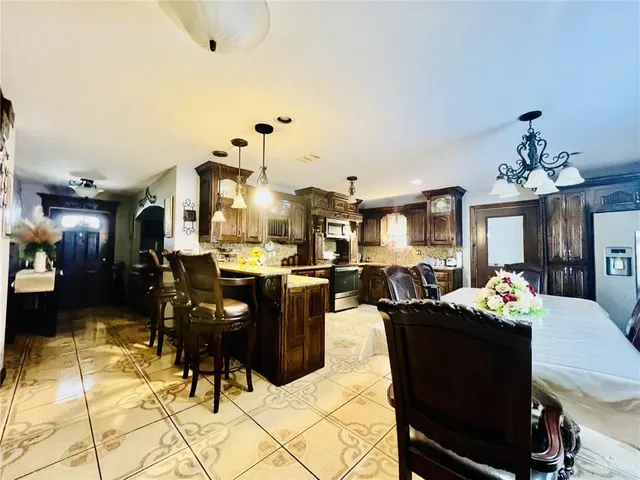 a living room with dining table and chairs