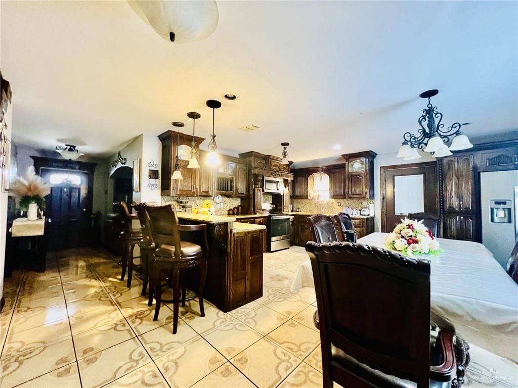 5 Montalvo Hill Road Rio Grande City, TX 78582 - Photo 10 of 42 a living room with dining table and chairs