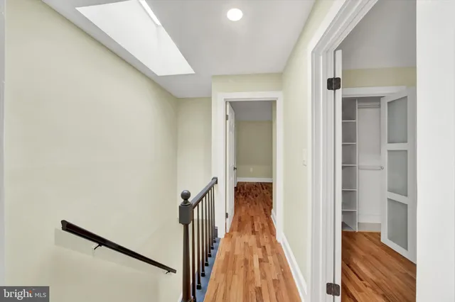 a view of a hallway with a white walls and stairs