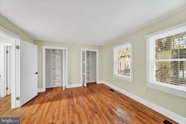 a view of a livingroom with wooden floor and window
