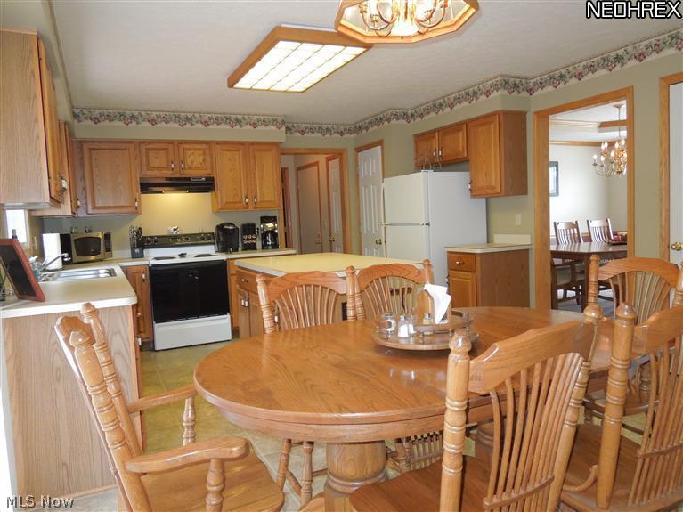 3828 Boston Road Brunswick, OH 44212 - Photo 12 of 16 Kitchen Casual Dining Area from the Slider to the Deck! Pantry and Hall to the First Floor Laundry, Garage & Half Bath in Background!