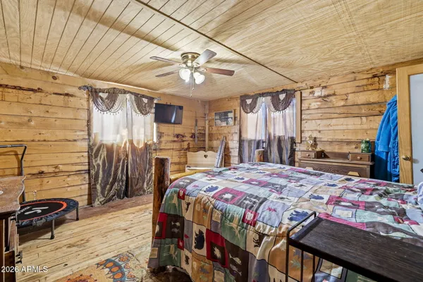 a bedroom with two beds and a chandelier