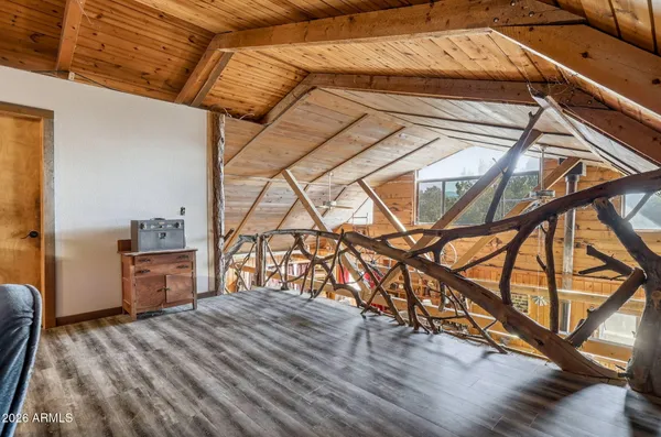 a room with a bed and wooden floor