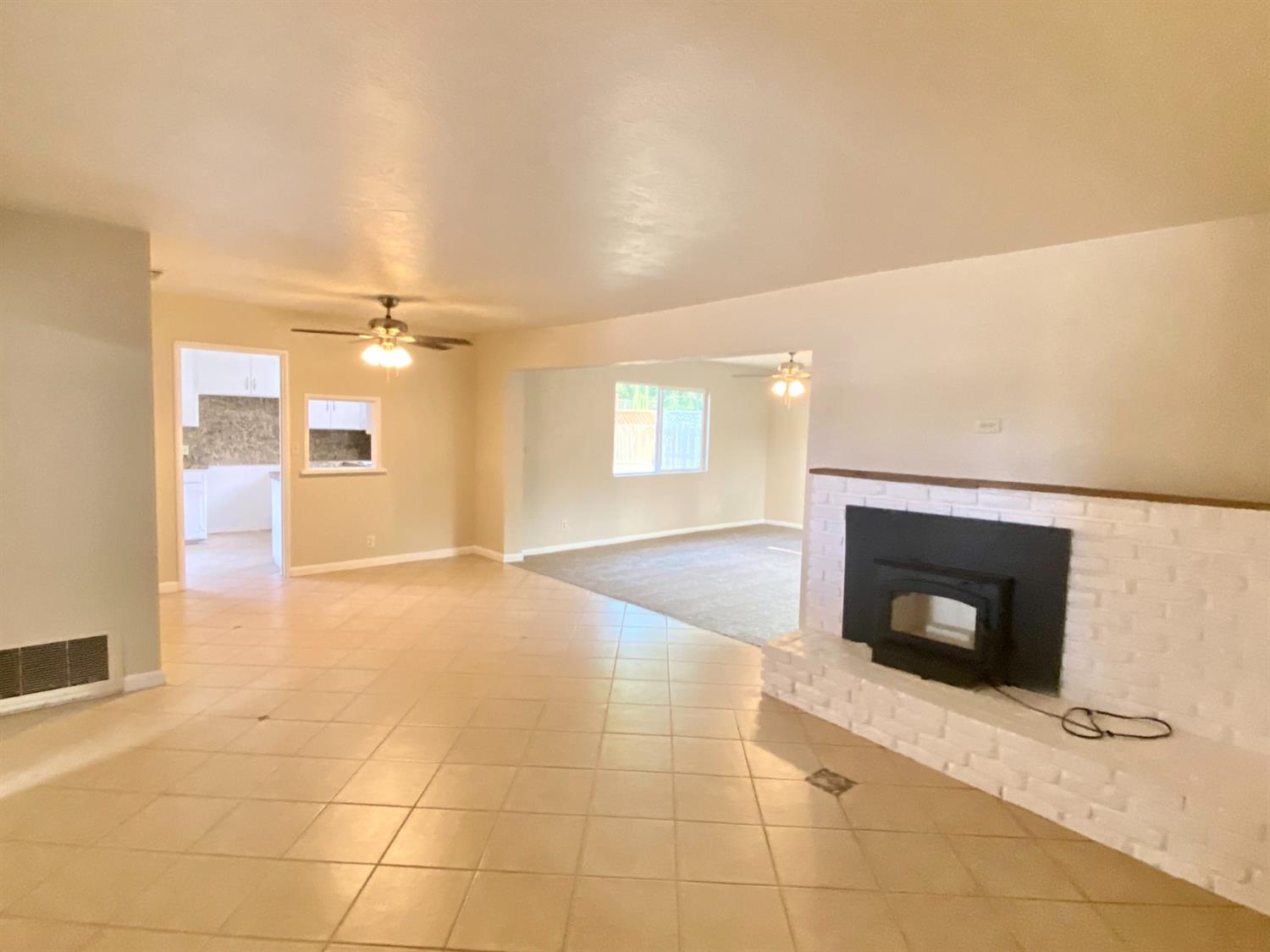 3310 East Hampton Way Fresno, CA 93726 - Photo 2 of 18 a view of a livingroom with a fireplace and a rug