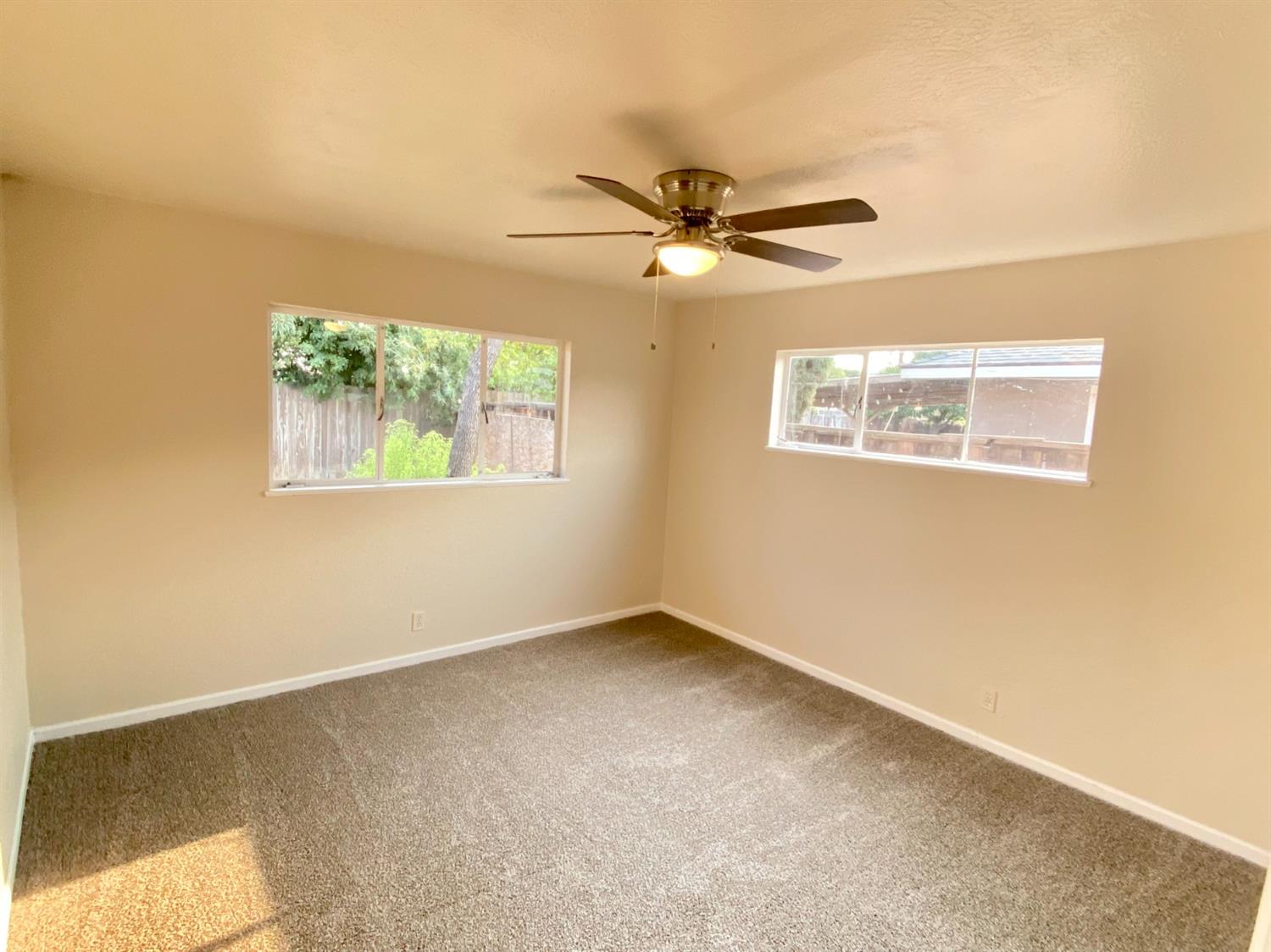 3310 East Hampton Way Fresno, CA 93726 - Photo 13 of 18 a view of an empty room with a window