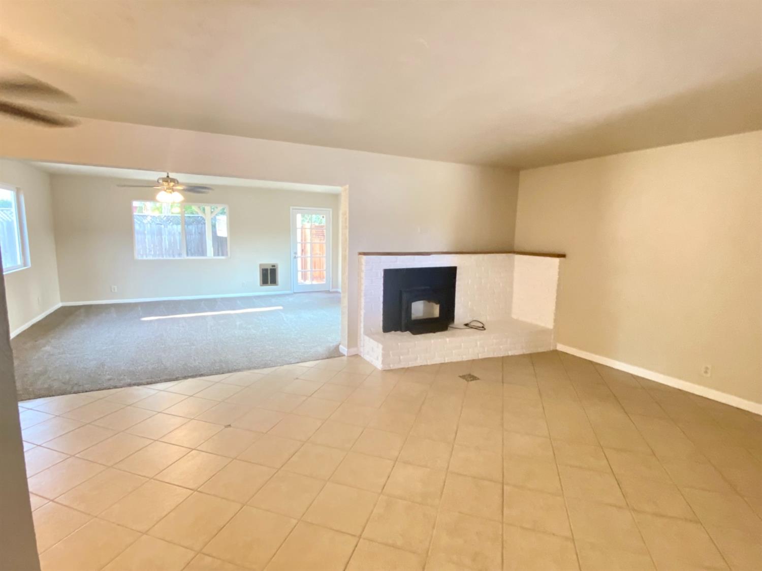 3310 East Hampton Way Fresno, CA 93726 - Photo 5 of 18 a view of empty room with a fireplace