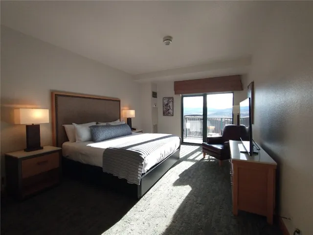 a bedroom with a bed and lamp