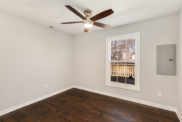 516 Amherst Avenue Romeoville, IL 60446 - Photo 8 of 15 an empty room with wooden floor and windows