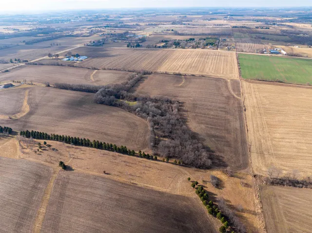 an aerial view of a house with a yard and lake view