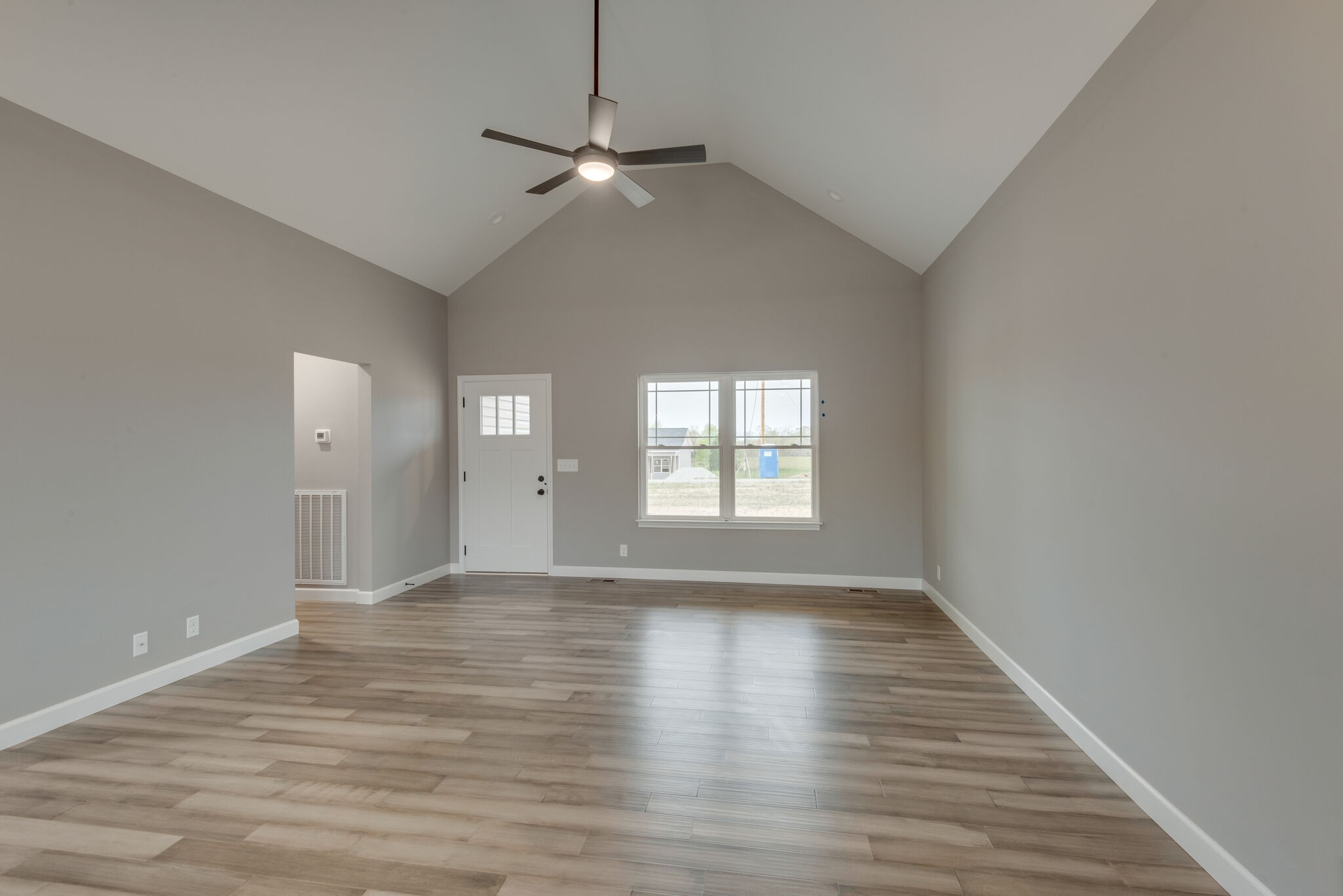 1271 Oak Grove Road Dickson, TN 37055 - Photo 6 of 18 a view of an empty room with wooden floor and a window