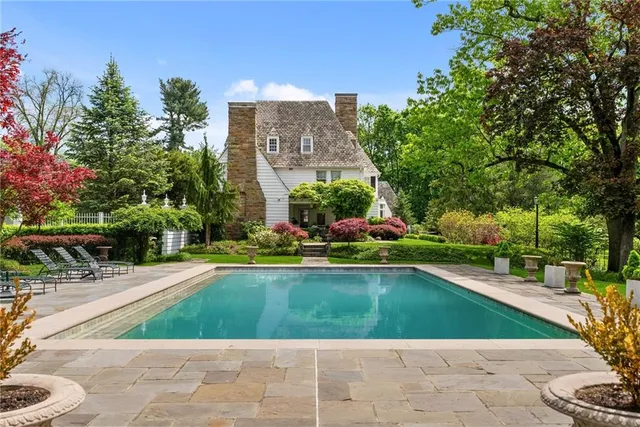 a view of a swimming pool and a yard